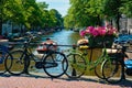 Amsterdam canal with boats and bicycles on a bridge Royalty Free Stock Photo
