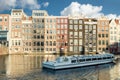 Amsterdam canal cruise ship with Netherlands traditional house Royalty Free Stock Photo