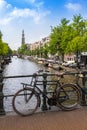 Amsterdam canal scene with bicycles and bridges Royalty Free Stock Photo