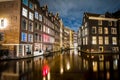 Amsterdam canals and houses against night cityscape of Amsterdam, Holland Netherlands Royalty Free Stock Photo