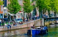 Amsterdam Canals and people enjoying spare time on their boats on a sunny day Royalty Free Stock Photo