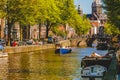 Amsterdam Canals and people enjoying spare time on their boats on a sunny day Royalty Free Stock Photo