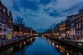 Amsterdam in the evening, houses with a system of canals and narrow houses with gable facades in the evening