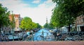 Channels and vintage bicycles on Amsterdam street. The capital of the Netherlands on a sunny summer day.