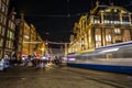 Amsterdam city night streets with different kinds moving transport & silhouettes of passersby. Royalty Free Stock Photo