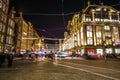 Amsterdam city night streets with different kinds moving transport & silhouettes of passersby. Royalty Free Stock Photo