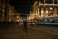 Amsterdam city night streets with different kinds moving transport & silhouettes of passersby. Royalty Free Stock Photo