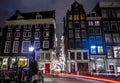 Amsterdam city night streets with different kinds moving transport & silhouettes of passersby. Royalty Free Stock Photo