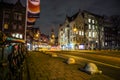 Amsterdam city night streets with different kinds moving transport & silhouettes of passersby. Royalty Free Stock Photo