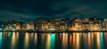 Amsterdam City panorama, illuminated buildings or dancing houses with reflection in water canal at night, Netherlands Royalty Free Stock Photo