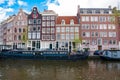 Amsterdam cityscape with houseboats along the canal, Netherlands.