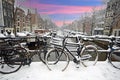 Amsterdam covered with snow with the Westerkerk in winter in the Netherlands at sunset Royalty Free Stock Photo