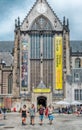 New church on the Dam Square in the summer, people on the streets shopping