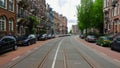 Amsterdam, downtown, people, cars on street, view from tram, Holland on a cloudy day