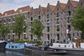 Warehouses with slanted roof in Amsterdam with canal and boats