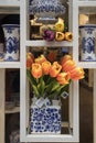 Showcases of Dutch shops with blue typical dishes and skulls