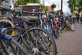 Amsterdam, Holland. August 2019. Bicycles parked along the canals are a symbol of the city. A bike with a red racing frame stands Royalty Free Stock Photo