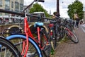 Amsterdam, Holland. August 2019. Bicycles parked along the canals are a symbol of the city. A bike with a red racing frame stands Royalty Free Stock Photo