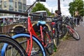 Amsterdam, Holland. August 2019. Bicycles parked along the canals are a symbol of the city. A bike with a red racing frame stands Royalty Free Stock Photo