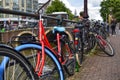 Amsterdam, Holland. August 2019. Bicycles parked along the canals are a symbol of the city. A bike with a red racing frame stands Royalty Free Stock Photo