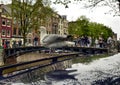 Amsterdam, Holland, August 201. In the central red-light district a gull on the roof of a car along the canals. The typical houses