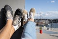 Amsterdam, Holland - August 2019: Couple relaxing on a modern design bench in NEMO Science museum Amsterdam rooftop park with a