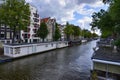 Amsterdam,Holland,August 2019. In the historic center a view that is a symbol of the city: a blue houseboat moored on the edge of