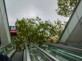 Amsterdam, Holland, August 2019. Metro station: perspective view of the escalators leading to the surface. On the left the logo