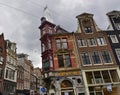 Amsterdam, Holland, August 2019. Rainy day in the old town. Among the typical little houses, a corner with a red bay window Royalty Free Stock Photo