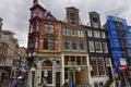 Amsterdam, Holland, August 2019. Rainy day in the old town. Among the typical little houses, a corner with a red bay window Royalty Free Stock Photo