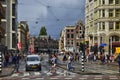 Amsterdam, Holland. August 2019. A road junction in the center: the typical houses, cars, bikes, pedestrians, tram rails coexist. Royalty Free Stock Photo
