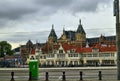 Amsterdam, Holland, August 2019. In a single view the central metro station, with its white facade, and behind it the tallest and