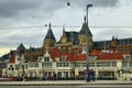 Amsterdam, Holland, August 2019. In a single view the central metro station, with its white facade, and behind it the tallest and