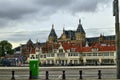 Amsterdam, Holland, August 2019. In a single view the central metro station, with its white facade, and behind it the tallest and