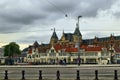 Amsterdam, Holland, August 2019. In a single view the central metro station, with its white facade, and behind it the tallest and