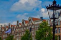 Amsterdam, Holland, August 2019. The typical and charming houses: they are a symbol of the city represented on a postcard. With