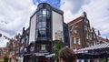 Amsterdam, Holland, August 2019. Among the typical historic houses of the center, there is a bar with a modern glass and metal