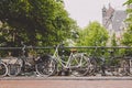 Amsterdam, Holland, May 12 2018: Old bicycle parked on a canal bridge in Amsterdam Royalty Free Stock Photo