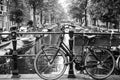 Amsterdam, Holland, May 12 2018: Old bicycle parked on a canal bridge in Amsterdam Royalty Free Stock Photo