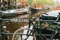 Amsterdam, Holland, May 12 2018: Old bicycle parked on a canal bridge in Amsterdam Royalty Free Stock Photo