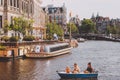 Amsterdam, Holland, May 11th 2018: Family enjoying a boat trip on a canal in the city of Amsterdam