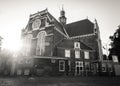 Amsterdam, Holland, the Netherlands - July 6 2020: Noorderkerk in Amsterdam with the sun peaking over the building shot in black