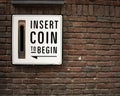 Insert Coin to begin - random street art on a brick wall in Amsterdam Holland