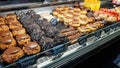 A display of cakes and sweet treats in a cafÃÂ© in Amsterdam. Nutella and Oreo muffins,