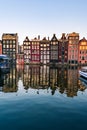 Amsterdam houses with colorful facades and cruising boats at the Amstel river canal Royalty Free Stock Photo