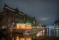 Night view over the last part of the Rokin where still water is with in the foreground the office of the canal cruise comapny Kooi Royalty Free Stock Photo