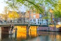 Amsterdam In The Morning Sun. Traditional Old Houses And Bridges. Beautiful Morning In Amsterdam