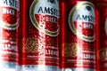 Amstel beer cans in a row, close up, water droplets / condensation on the beer can.