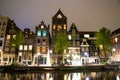 Amsterdam canal Singel with typical dutch houses and houseboats by night Royalty Free Stock Photo