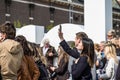 Amsterdam , Netherlands - April 31, 2017 : Asian lady taking selfies while people walking around in the streets